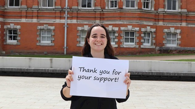 Student holding up a thank you sign