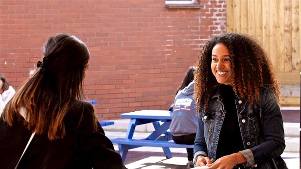 Two female students having a chat